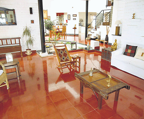 ETHNIC (Clockwise) The drawing room with red Athangudi tiles; the open 'puja' room and the porch. (Photos by the author)