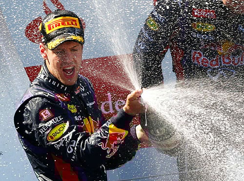 Red Bull Formula One driver Vettel of Germany sprays champagne on the podium after winning the German F1 Grand Prix at the Nuerburgring racing circuit reuters