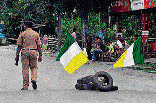 Villagers sit outside shuttered shops on the first day of a  72-hour Gorkha People's Liberation Front strike  in  Garidhura village on Monday. AFP