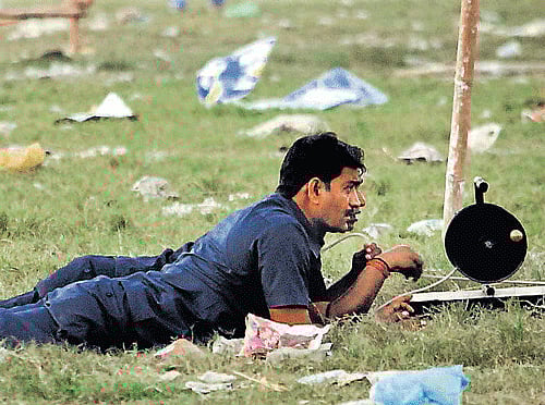 Security personnel inspect the site of a bomb blast in Patna on Monday. Reuters