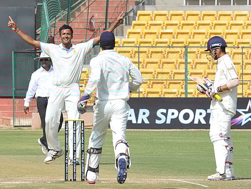 Karnataka's HS Sharath celebrates dismissal of Mumbai's Siddesh Lad at Chinnaswamy Stadium in Bangalore on Wednesday. DH Photo Srikanta Sharma R