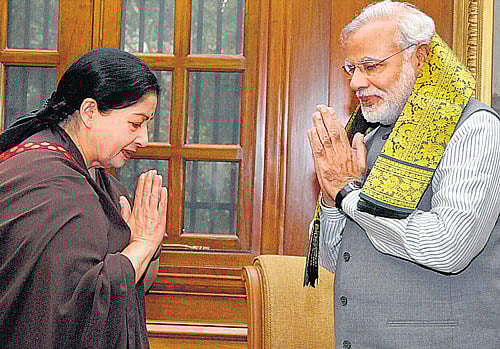 Prime Minister Narendra Modi exchanges greetings with Tamil Nadu Chief Minister J Jayalalitha at a meeting in New Delhi on Tuesday. PTI