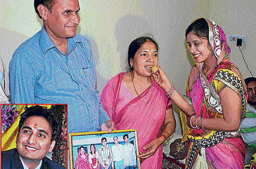 Family members of Gaurav Agrawal (inset) celebrate at their home in Jaipur on Thursday. PTI Photo