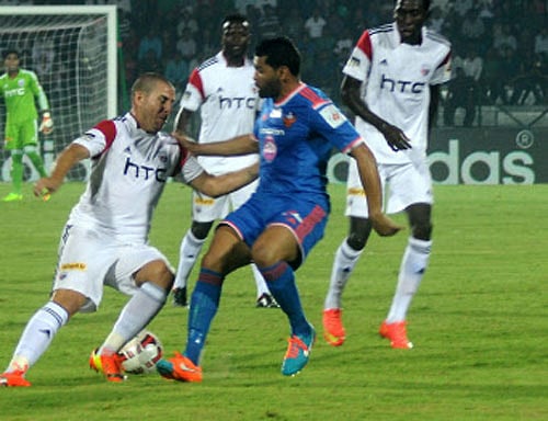 Players in action during a football match played between North East United FC and Goa FC at Indira Gandhi Stadium in Guwahati on Sunday. PTI Photo