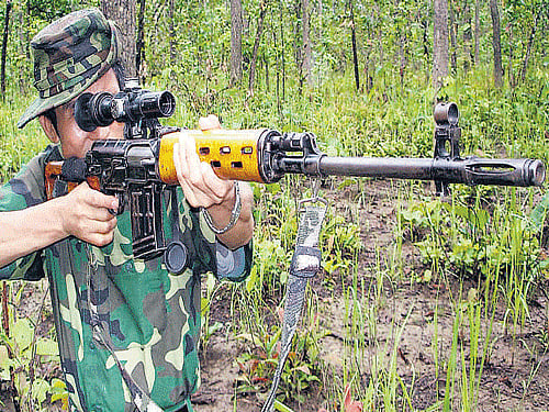 A cadre of the Manipur-based People's Liberation Army with sophisticated weapon at the outfit's hideout. PTI FILE PHOTO