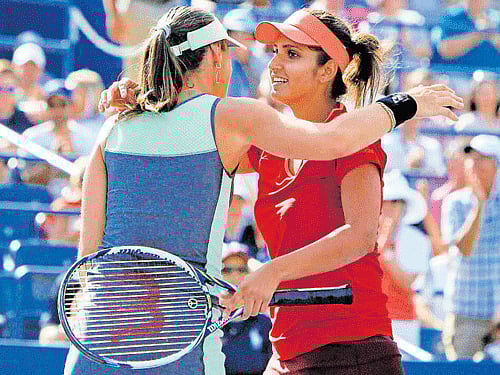 smooth ride Sania Mirza (right) and Martina Hingis  embrace each other after their win on Sunday. pti