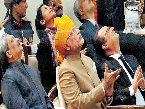 Prime Minister Narendra Modi with French President Francois Hollande and Defence Minister Manohar Parikkar watch the flypast during the 67th Republic Day parade in New Delhi on Tuesday. PTI