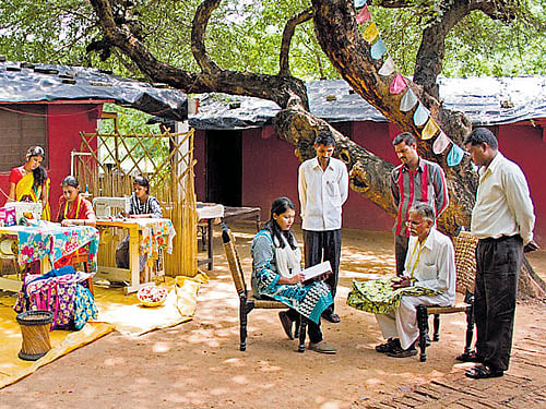 Divya Srivastava with tribal people. (below) Tribal men get ready to print a design on cloth.