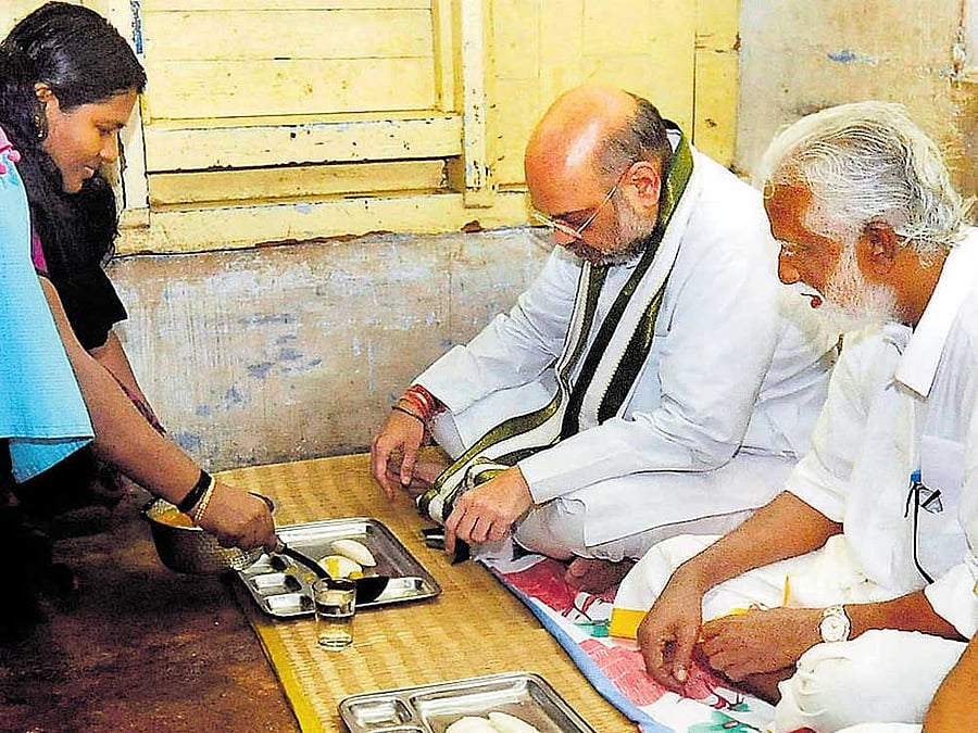 BJP president Amit Shah and party's Kerala unit chief  Kummanam Rajasekharan have breakfast at the residence of  a party worker in Thiruvananthapuram on Sunday. PTI