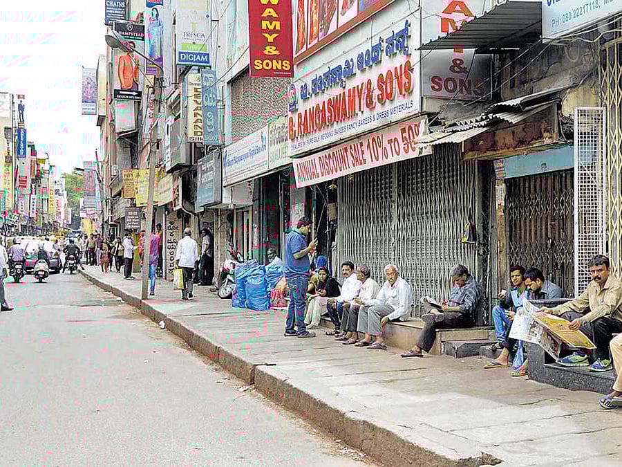 voices of dissent: Textile shops remained closed on Chickpet main road as traders in the city opposed the GST regime on Friday. These women shoppers, who came for deals, were caught unawares as traders downed the shutters in the pete areas. dh Photos