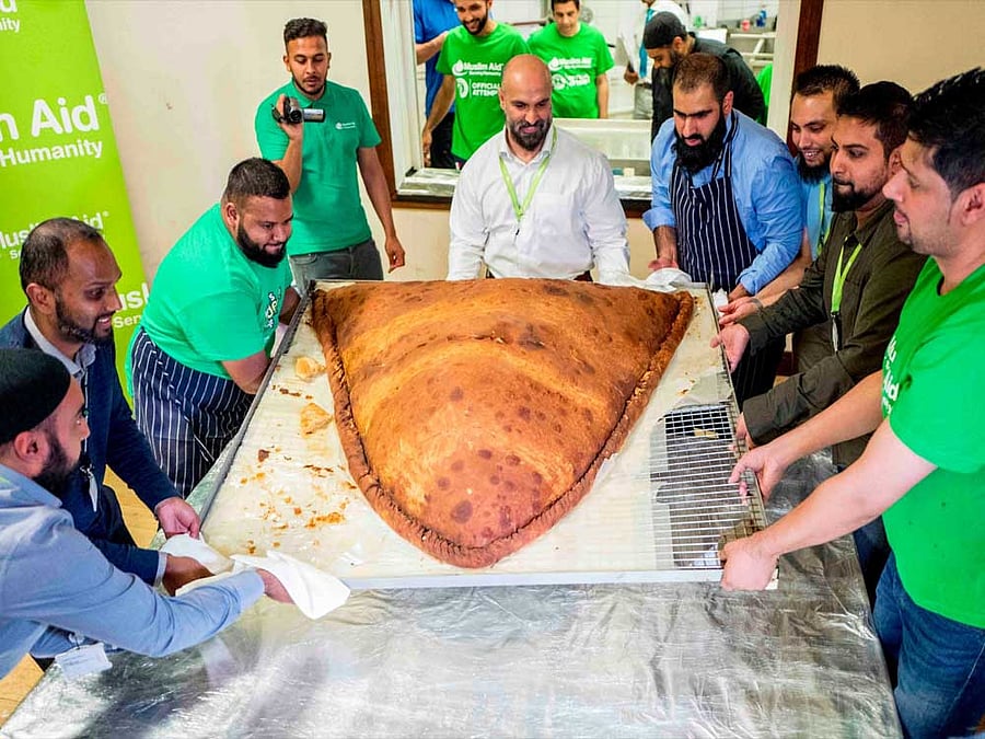 After Guinness World Records officials approved their feat, the team distributed the gigantic samosa, that took over 15 hours to make, to homeless people around Whitechapel. (Source: Catrin Nye/Twitter)