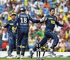 Deccan Chargers' Pragyan Ojha (R) celebrates with teammates after claiming the wicket of Chennai Super Kings skipper M S Dhoni during their IPL T20 match in Nagpur on Saturday. PTI Photo