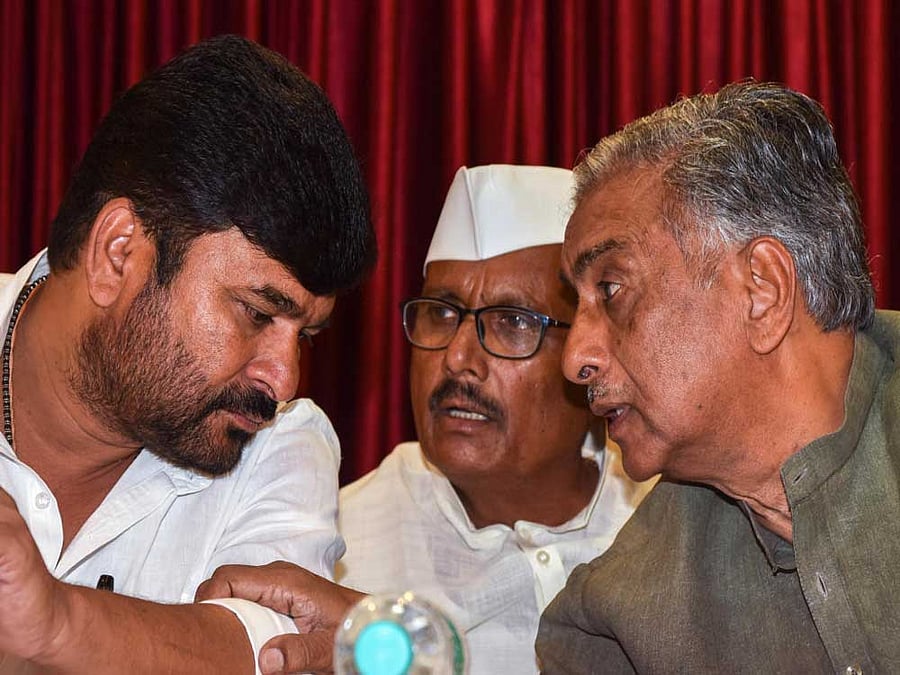 Minister Vinay Kulkarni and legislators B R Patil and Basavaraj Horatti at a press conference in Bengaluru on Thursday.