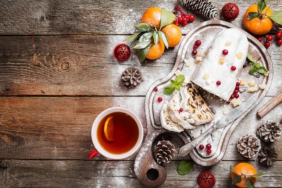 Christmas stollen, traditional German, European festive dessert cut into pieces on wooden background.