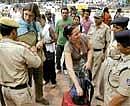 Keeping Vigil: Security personnel check bags of foreign tourists as they enter Janpath market in New Delhi on Saturday. AP