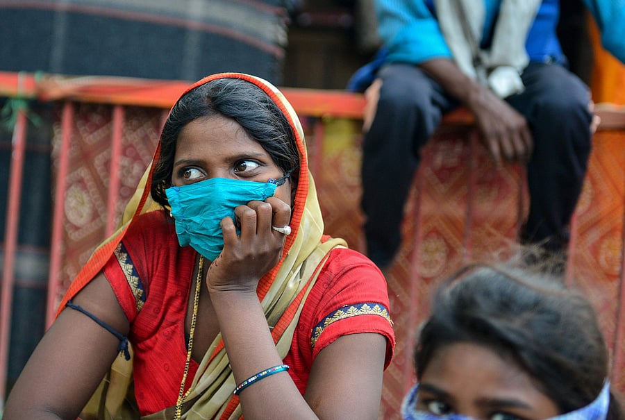 Migrant workers and families who arrived from Maharashtra state wait for transport to go back to their hometowns, after the government eased a nationwide lockdown imposed as a preventive measure against the COVID-19. (AFP Photo)