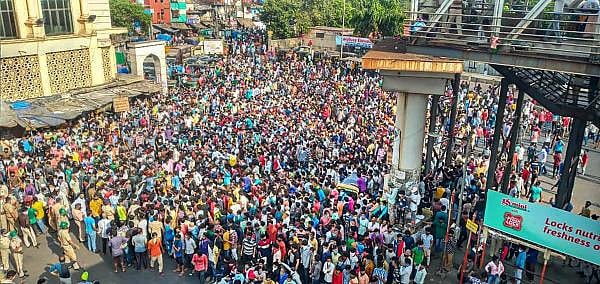 Migrant workers gather outside Bandra West Railway Station as they defy lockdown norms and request to leave for their native places after Prime Minister Narendra Modi had announced the extension of nationwide lockdown till May 3 in the wake of coronavirus pandemic, in Mumbai, Tuesday, April 14, 2020. (Credit: PTI Photo)