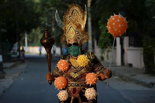 A man dressed as 'Yamraj', the Hindu mythical angel of death, campaigns to raise awareness on the importance to stay home and maintain social distancing during an event organised by Delhi police as India continues to remain under a nationwide lockdown as a preventive measure against the spread of the COVID-19 coronavirus, in New Delhi on April 28, 2020. (AFP Photo/Sajjad Hussain)