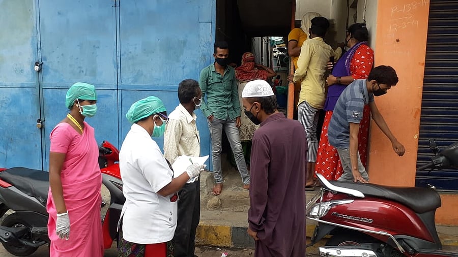 Padarayanapura, JJR Nagar, ASHA and health workers going house-to-house to prepare for complete lockdown in two wards of Bengaluru. (Credit: DH Photo/S K Dinesh)