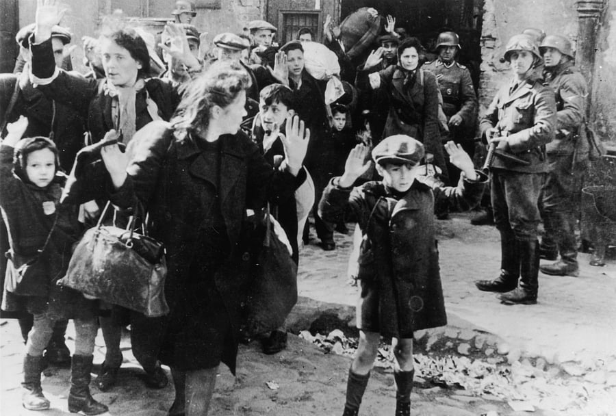 Jews from the Warsaw ghetto surrender to German soldiers after the Warsaw Ghetto Uprising of April-May 1943. On the right is SS Josef Blösche (1912 - 1969). (Photo by Getty Images)
