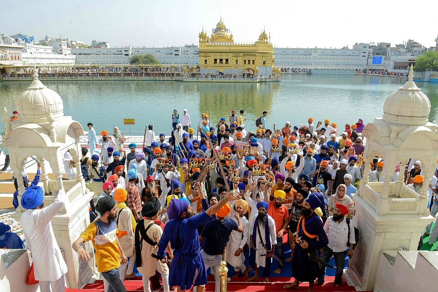 Indian Sikh radical activists hold swords and leaflets as they shout pro-Khalistan (Sikh separatist movement) and anti-government slogans after prayers at the Golden Temple in Amritsar. AFP photo