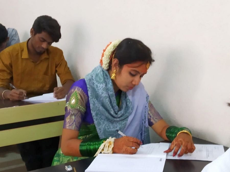 Harshitha writing the M.Com examination after her wedding. Credit: DH Photo