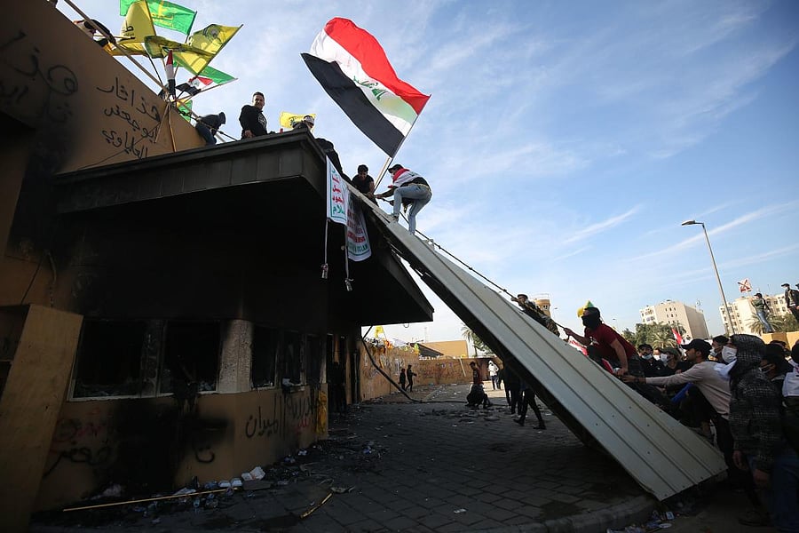 Supporters and members of the Hashed al-Shaabi military network gather during a demonstration outside the US embassy in the Iraqi capital Baghdad. (AFP Photo)