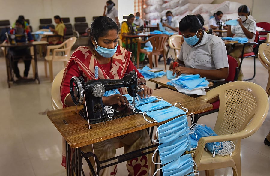 Workers stitch masks for police personnel during a government-imposed nationwide lockdown as a preventive measure. (Credit: PTI Photo)