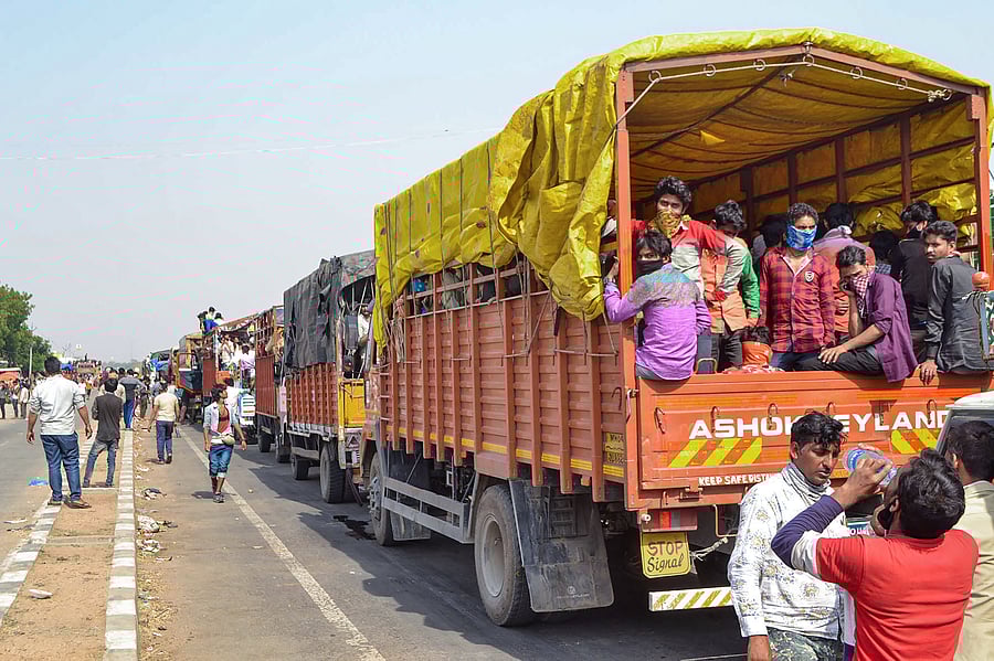 Migrant workers travel in crowded trucks during the ongoing COVID-19 lockdown. (PTI Photo)