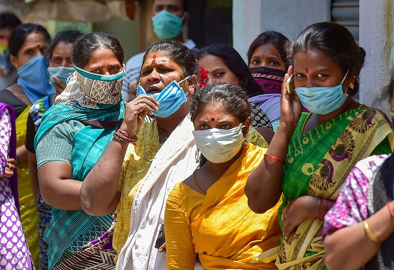 Residents of Sudamanagar, a COVID-19 hotspot area, queue up to collect ration kits during the ongoing nationwide lockdown imposed in the wake of novel coronavirus pandemic in Bengaluru. (PTI Photo)