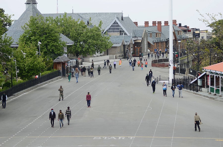 Locals walk along the Ridge during curfew relaxation hours, amid the nationwide lockdown to curb the spread of coronavirus, in Shimla. (Credit: PTI Photo)