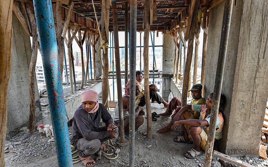 Labourers sit at an under construction building during nationwide lockdown in Kolkata, (Credit: PTI)