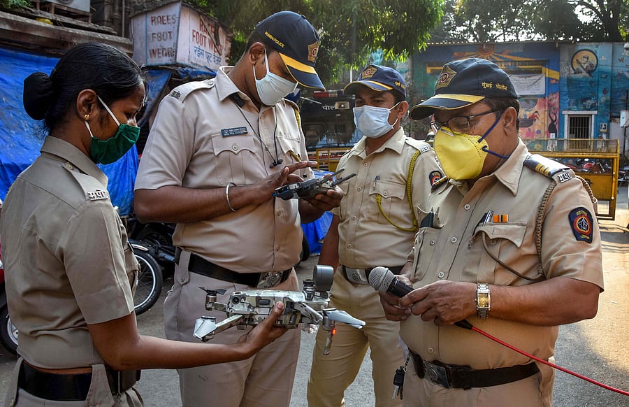 Police manoeuvre a drone to check people's movement during a 21-day nationwide lockdown, a measure to prevent the spread of coronavirus, at a market in Mumbai. (Credit: PTI)