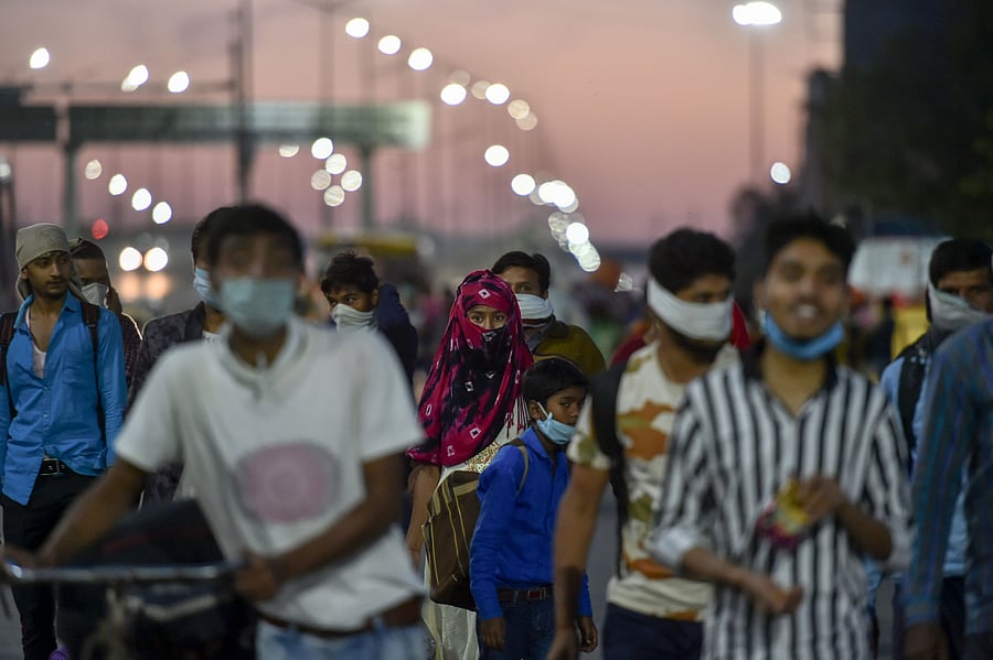 Migrants along with their family members walk to their villages amid the nationwide lockdown, in the wake of coronavirus pandemic, at Delhi Uttar Pradesh Border. (PTI Photo)