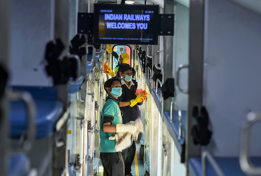 Railway workers disinfect the coaches of Delhi –Jammu Rajdhani Express train in wake of coronavirus pandemic at New Delhi Railway Station, Sunday, March 15, 2020. (PTI Photo/Arun Sharma)