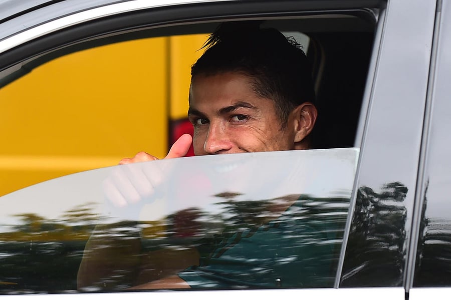 Juventus' Cristiano Ronaldo gestures as he leaves Juventus Training Center following the outbreak of the coronavirus disease (COVID-19), Turin, Italy, May 19, 2020. REUTERS/Massimo Pinca  Close  Selecte