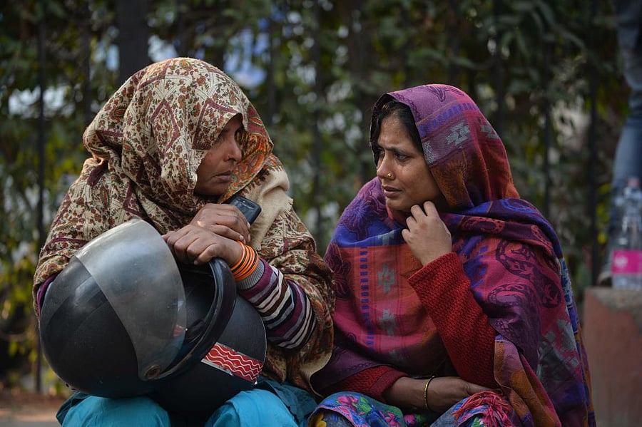 Fire victim relatives wait outside a hospital morgue in New Delhi after a factory fire broke out in Anaj Mandi area. AFP