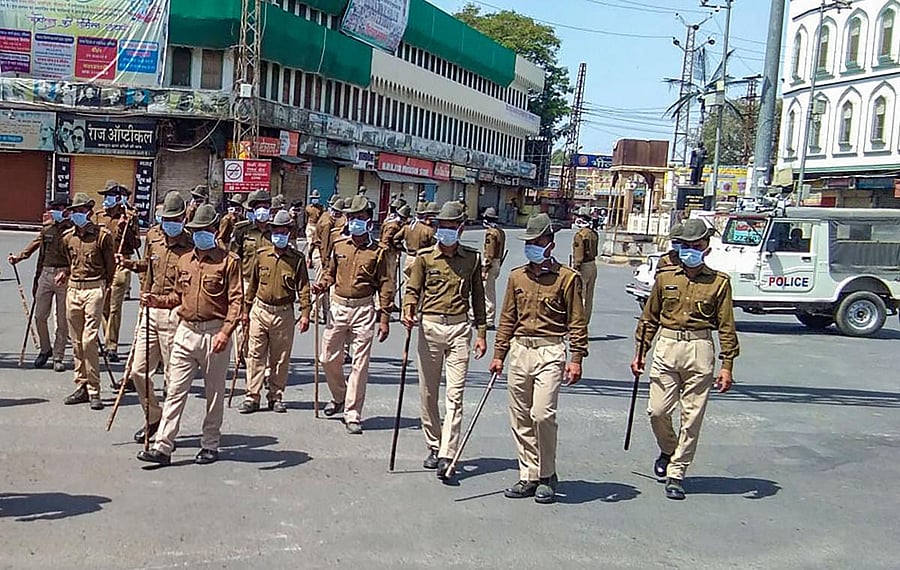 Police officials wear masks as they patrol during restrictions in the wake of deadly coronavirus, in Bhilwara (PTI Photo)