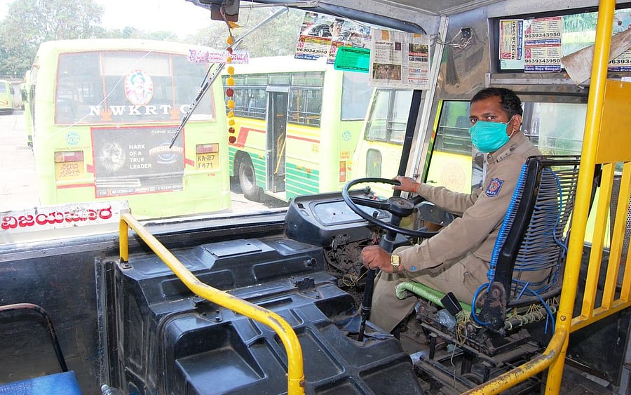 A driver checks the functioning of NWKRTC bus at the depot in Hubballi. (DH Photo)
