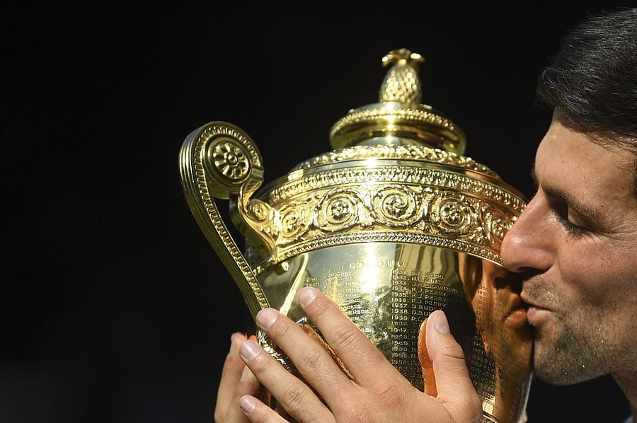 Novak Djokovic kisses the trophy after defeating Kevin Anderson of South Africa in the men's singles final match in London on Sunday.
