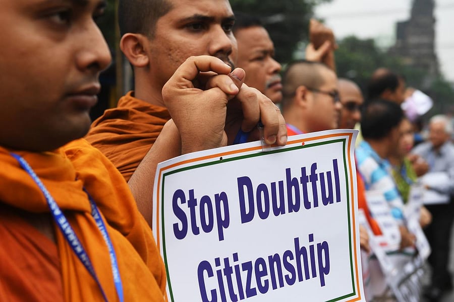 Social activists hold posters during a protest following the publication of a draft of the National Register of Citizens (NRC) in Kolkata on August 1, 2018. AFP