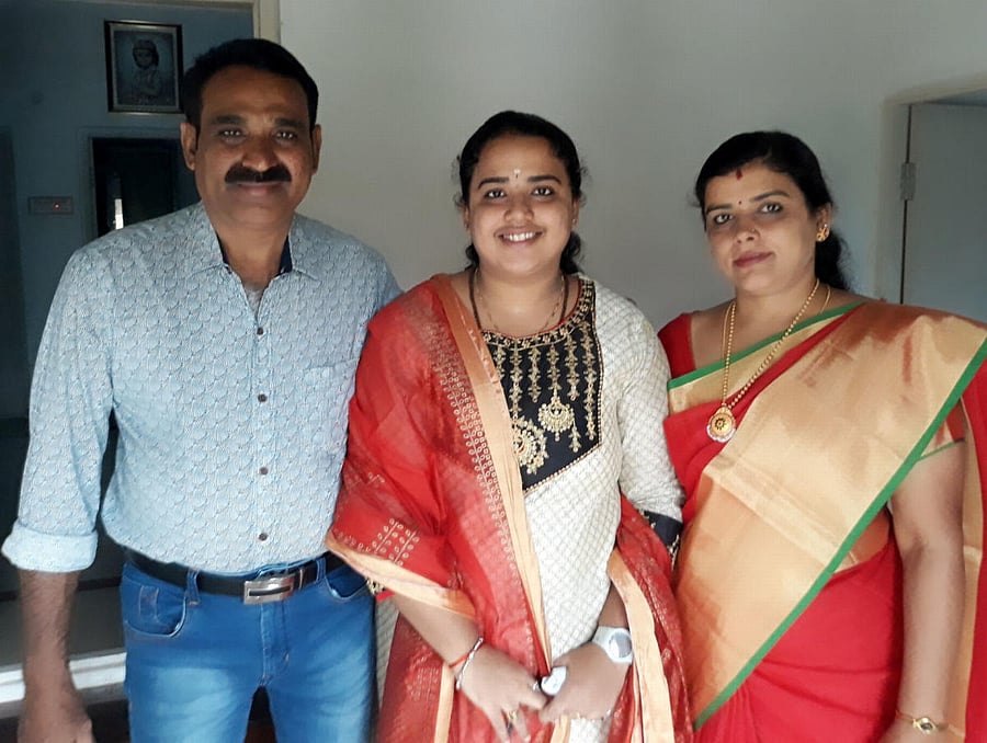 Ashwini A, who bagged 11 gold medals in BVSc, with her parents Ashok and Kasturi. dh photo