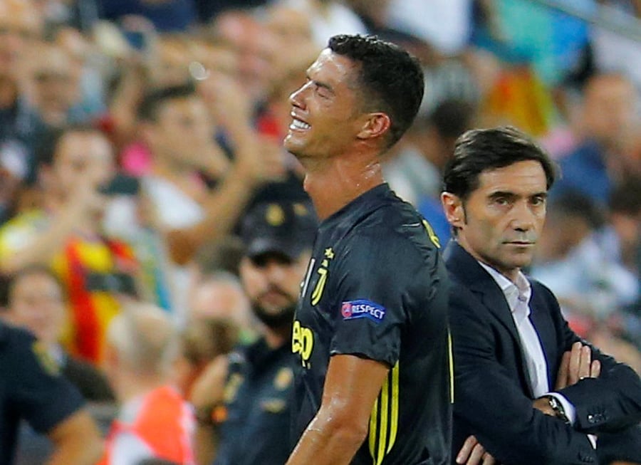 Juventus' Cristiano Ronaldo reacts after he is sent off while Valencia coach Marcelino Garcia looks on in the Champions League game on Wednesday. Reuters