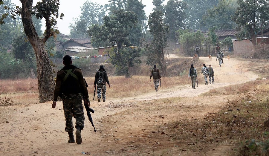 CRPF personnel patrol at Maoist affected area near village Sayu, in Latehar, on Dec. 5, 2018. PTI