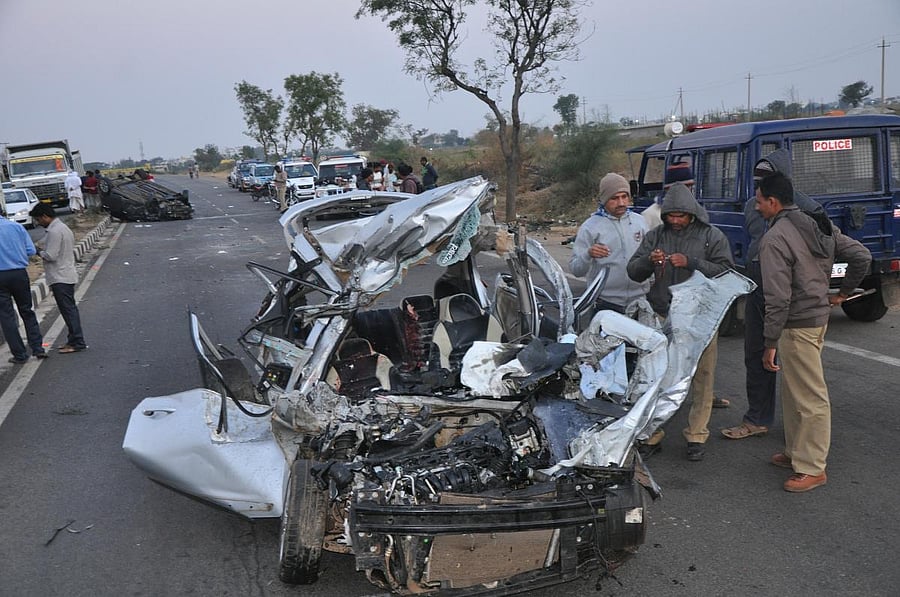 Police inspect the Hyundai i10 car which was split open following a collision with an i20 car near Gadag on Sunday. dh photo