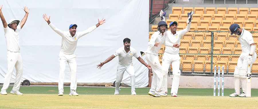 Karnataka's R Vinay Kumar (centre) along with his team-mates unsuccessfully appeal for a caught-behind verdict against Saurashtra's Cheteshwar Pujara during their Ranji Trophy semifinal at the M Chinnaswamy Stadium in Bengaluru on Sunday. DH Photo/ Srikanta Sharma R