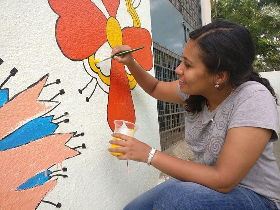 One of the volunteers paints the wall of a children's home in Bengaluru. FACEBOOK