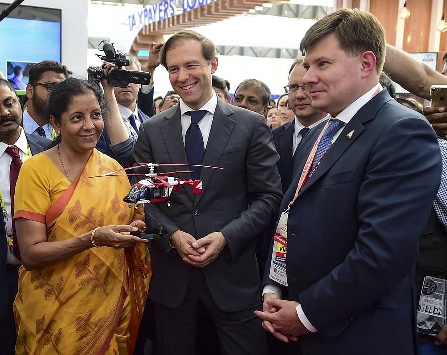 In one of the first business, deals struck at Aero India 2019, the Russian Helicopters Holding Company (a part of State Corporation Rostec) and a number of Indian companies signed Memorandums of Understanding. In photo: Union Defence Minister Nirmala Seetharaman receives a miniature helicopter as a memento from Russian stall after inauguration of the 12th edition of 'AERO India 2019' at Yelahanka Air Base, in Bengaluru, Wednesday, Feb 20, 2019. PTI photo.