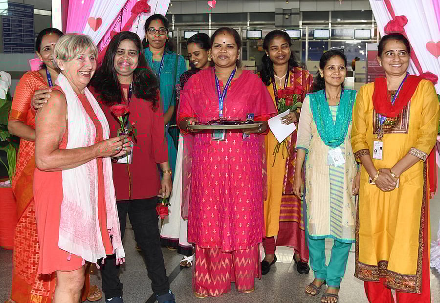 A woman passenger is greeted with a rose at Mangaluru International Airport in Bajpe, Mangaluru, on account of International Women’s Day, on Friday.