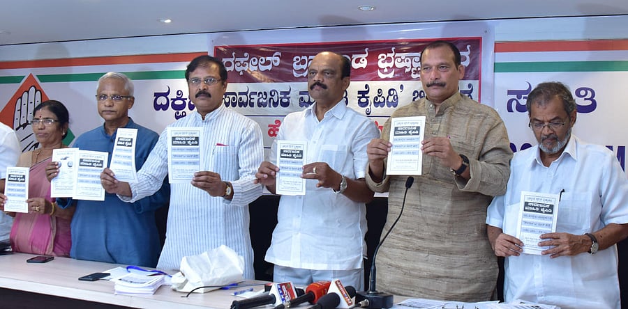 Senior Congress leader V R Sudarshan (3rd from left) releases a booklet on corruption in the Rafale deal in Mangaluru on Saturday.